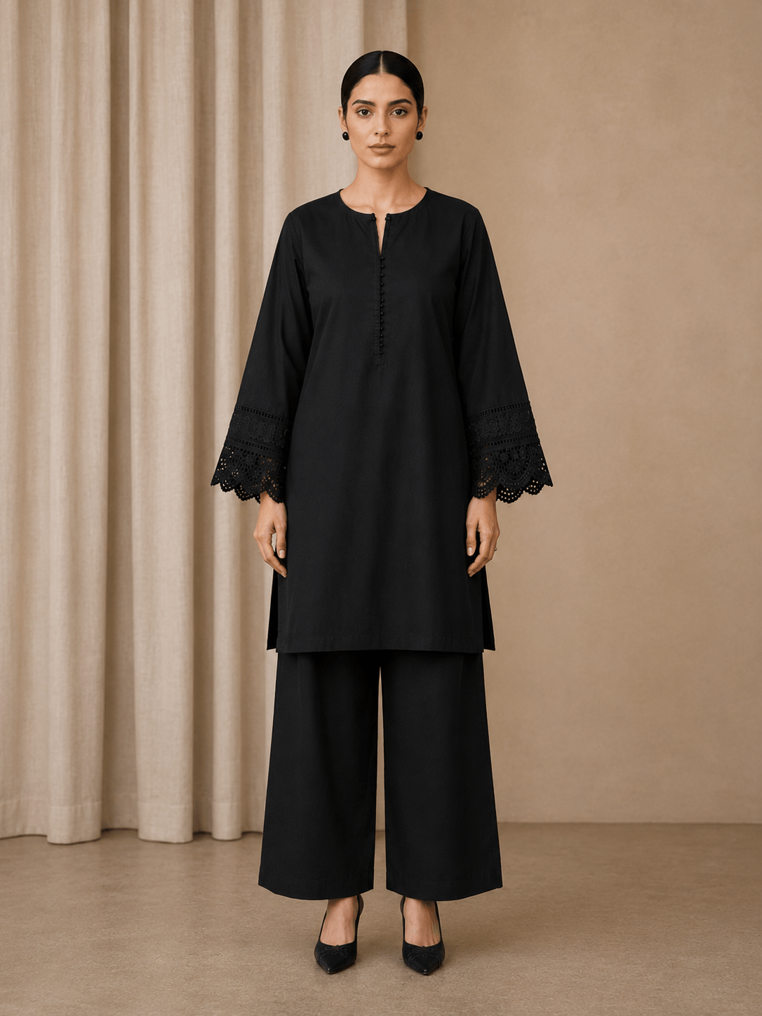 Side view of black cotton lawn kurta with lace cuffs and palazzo suit